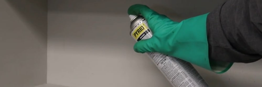 Pyrid Aerosol Pantry Application Spraying Pyrid Aerosol on a pantry shelf.